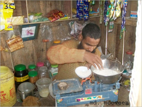 Mohammed Mobin weighing rice in his shop